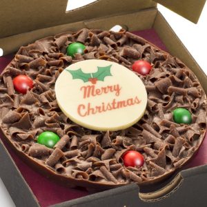 Mini chocolate pizza with Merry Christmas plaque on it